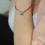 Evil Eye Teal Chai pendant on a red string bracelet