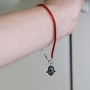 Evil Eye Hamsa pendant on a red string bracelet
